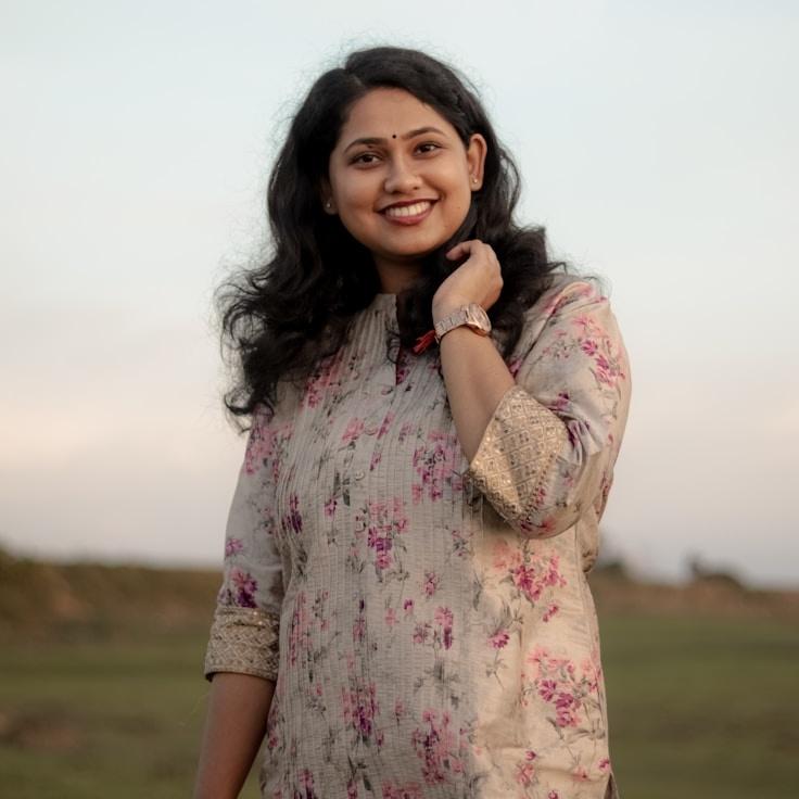 Avery Singh, Lead Design Curator at OpenBalancedRoad, reviewing corporate floral arrangements